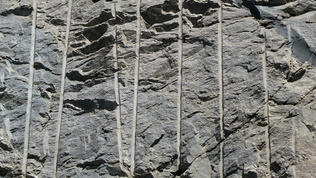 Explosives Drill Holes in the Rock